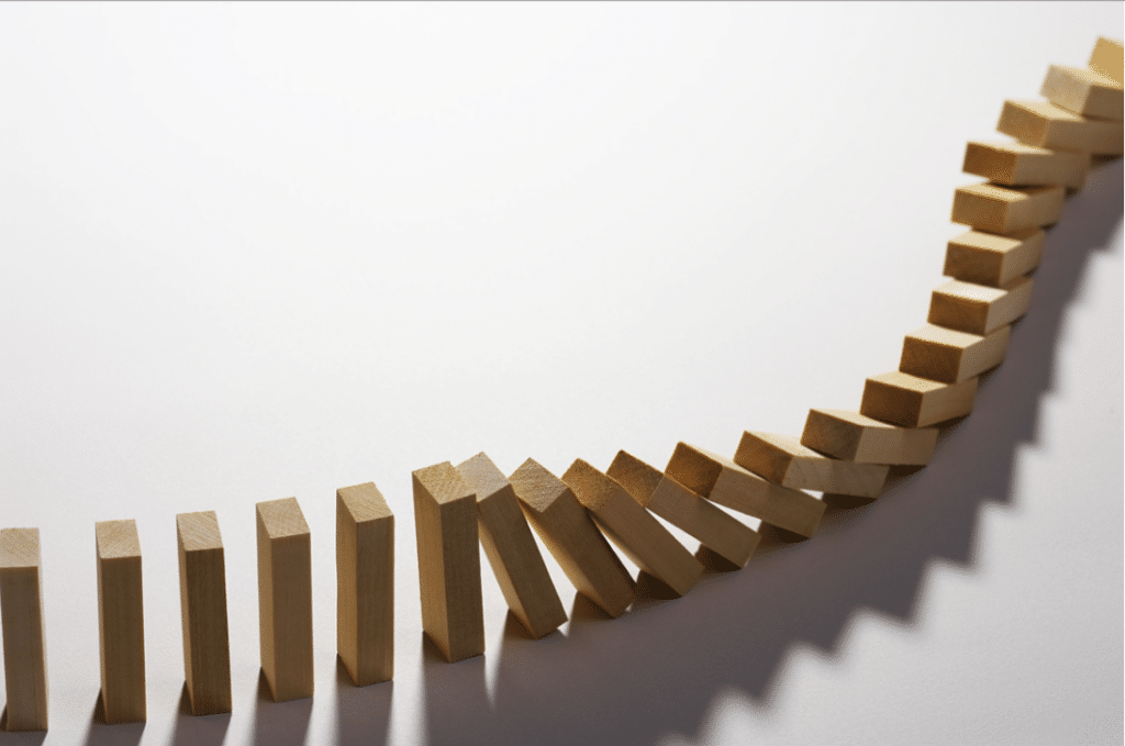 An image of dominoes falling. A representation of becoming a Regenerative Leader.